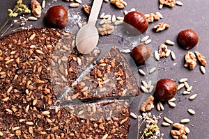 Close up of traditional castagnaccio cake slice, a classic italian gluten free autumn cake on wooden table made with chestnuts