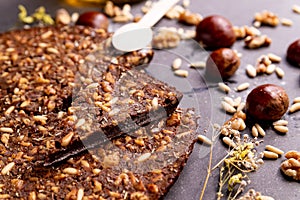 Close up of traditional castagnaccio cake slice, a classic italian gluten free autumn cake on wooden table made with chestnuts