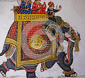 Close up of traditional detailed, colourful, Indian painting showing men on an elephant