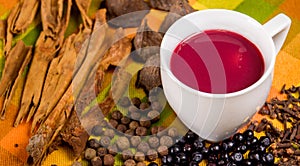 Close up of traditional Ecuadorian dish, colada morada and differente species over a colorful fabric