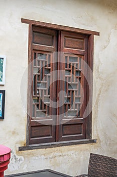 Close-up of traditional glass and wooden windows in ancient Chinese building