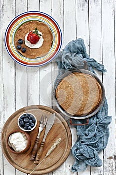 Close-up of Traditional homemade pancakes in plates on white background. Celebration of Maslenitsa.