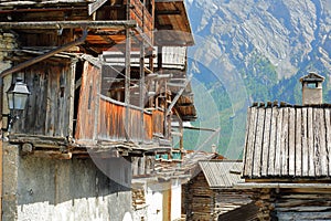 Close-up on traditional houses with traditional wooden balconies and wooden roofs in Saint Veran village