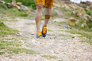 Close up of an athlete`s feet wearing sports shoes on a challeng photo