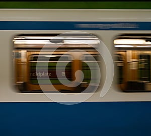 Close-up of a train arriving at a Munich subway station in Germany with a blurred effect