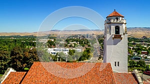 Close up of train depot clock tower with Boise in the background