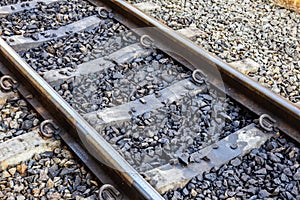 Close up of train or railroad tracks with cement backing In the countryside