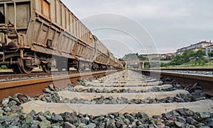 Close-up train rails and train wagons on background