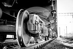 Close-up of a train wheel. Black and white photo with grainy effec