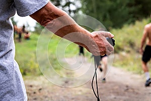 Close-up of a trainer holding a stopwatch