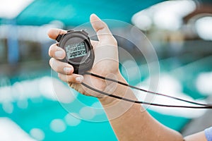 close up of a trainer& x27;s hand showing the time with a stopwatch