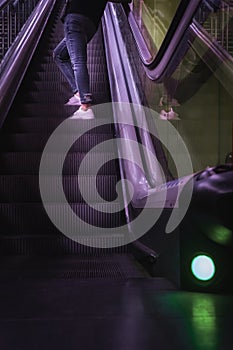 close-up of trainers going up the underground escalator
