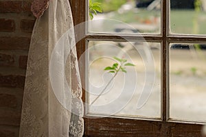 Close up of transparent white lace tulle on the window. Curtain and window interior decoration in vintage style