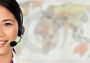 Close up of travel agent with headset against blurry map