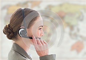 Close up of travel agent with headset against blurry map