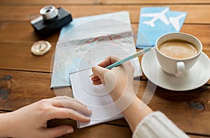 Close up of traveler hands with notepad and pencil