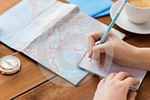 Close up of traveler hands with notepad and pencil