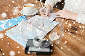 Close up of traveler hands with notepad and pencil