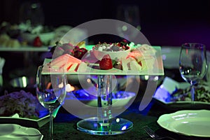 Close up of a tray of assorted rustic bread and cheese with olives and grapes.