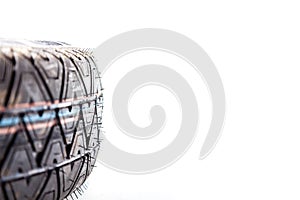 Close-up of the tread of a spare tire of a car on a white background in a photo studio with summer tires. Spare tire for