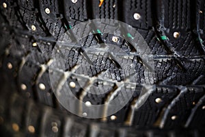 Close-up of the tread of winter rubber wheels for a car with spikes