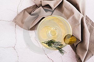 Close up of trendy martini cocktail with pickles and dill in a glass on the table top view