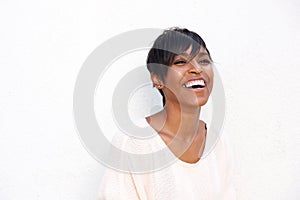 Close up trendy young black lady laughing against white background