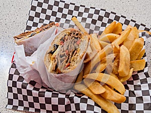 Close up of Tri-tip steak sandwich with french fries