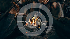 Close-up of Tribe Prehistoric Hunter-Gatherers Trying to Get Warm at the Bonfire, Holding Hands ov