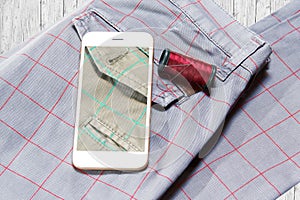 Close up of trousers with smartphone.