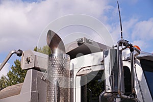 Close-up of a truck cab. Exhaust pipe visible