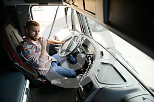 Close up of truck driver behind steering wheel. Copy space.