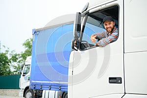 Close up of truck driver behind steering wheel. Copy space.