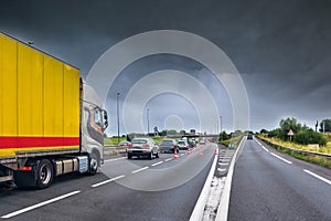 close-up truck driving on a highway in the storm