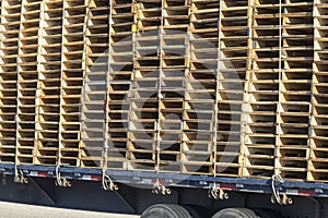 Close up of Truck loaded high with rectangular stacks of wooden pallets