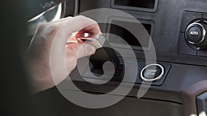 Close up of a truck or vehicle interior. Scene. Male hand starting a car.