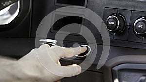 Close up of a truck or vehicle interior. Scene. Male hand starting a car.