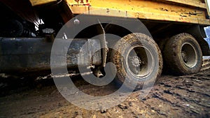 Close-up of truck wheels that ride in the swamp. Slow motion. Complex construction conditions. Shot by wide angle lens.