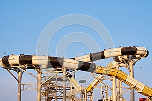 Close up of a tube water slide in aqua park against blue sky