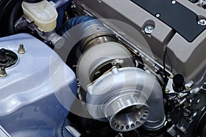 Close-up turbo engine on car bonnet for tune up