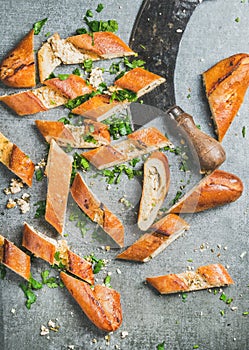 Close-up of Turkish pide cut in slices and kitchen chopper