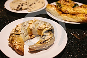 Turkish sweets - sweet bagel with filling sprinkled with pieces of nuts