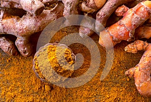 Close up turmeric powder on grunge wooden background.