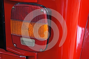 Close up of a turn signal lamp and brake of a retro car