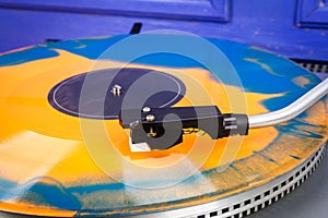 Close up of turntable needle on a vinyl