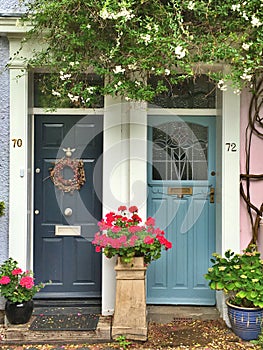Close up of two beautiful doors surrounded by flowers, Norwich, UK