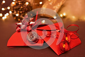 Close-up two beautiful little gift boxes decorated with ribbons and bow lie on a brown background