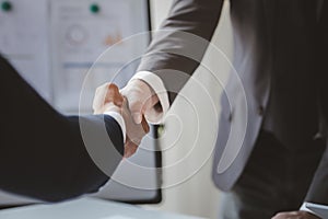 Close-up two business men holding hands, Two businessmen are agreeing on business together and shaking hands after a successful