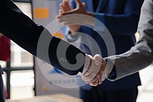 Close-up two business men holding hands, Two businessmen are agreeing on business together and shaking hands after a successful