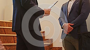 Close up of two business men in suit shaking hands